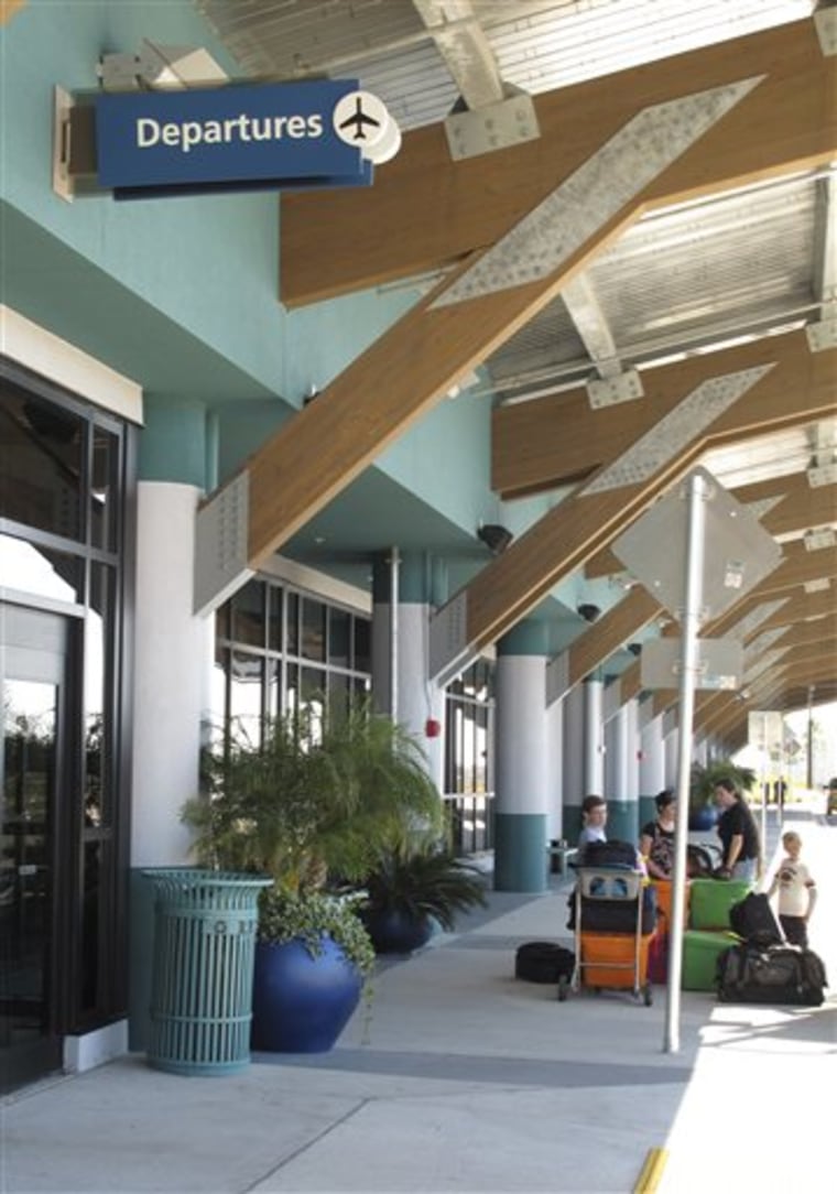 Passengers wait outside the Northwest Florida Beaches International Airport on Dec. 3 in Panama City, Fla. 